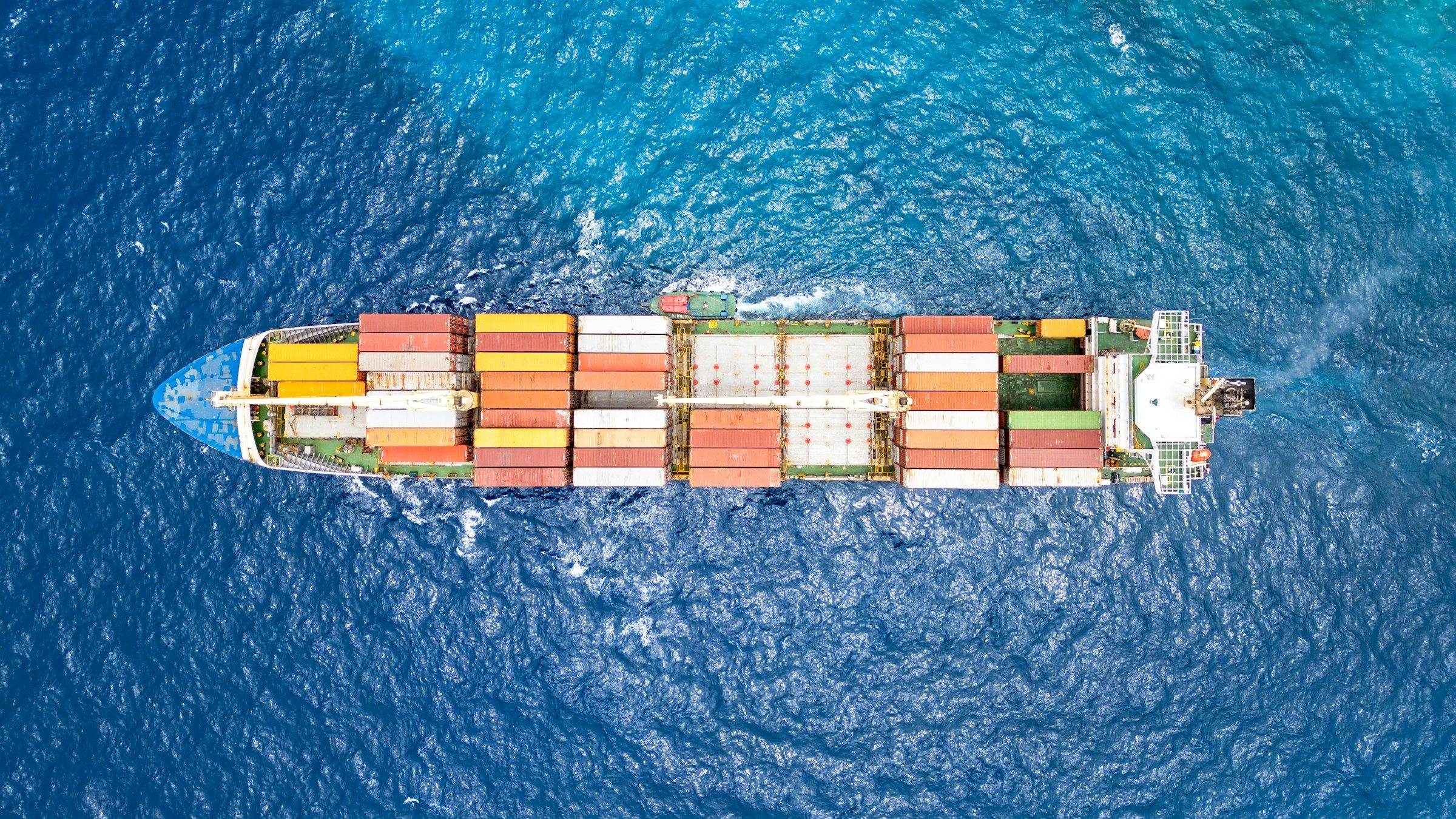 A container ship seen from directly above on blue sea