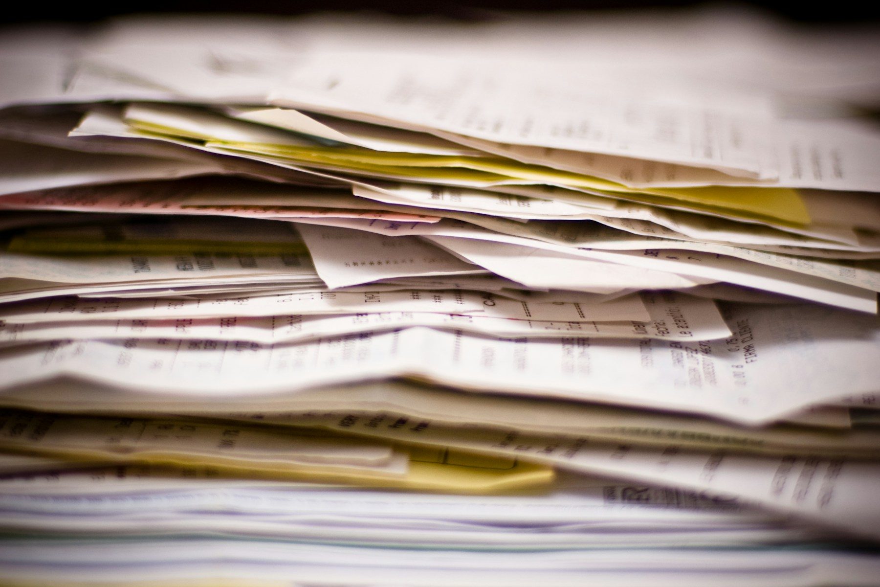 A thick stack of invoices, receipts and forms