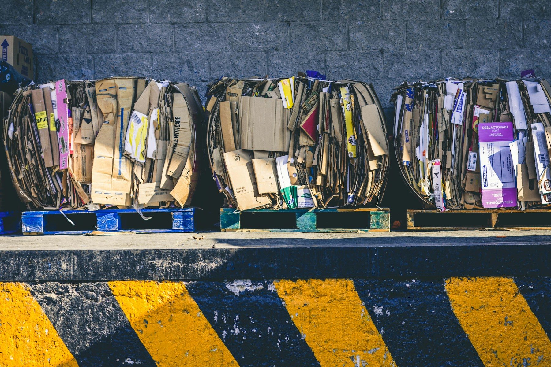Bales of cardboard stacked on pallets for recycling