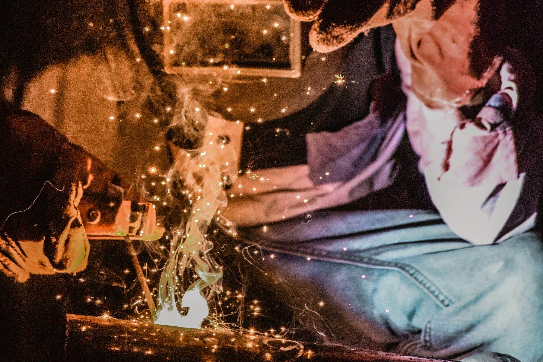 A welder at work with sparks flying